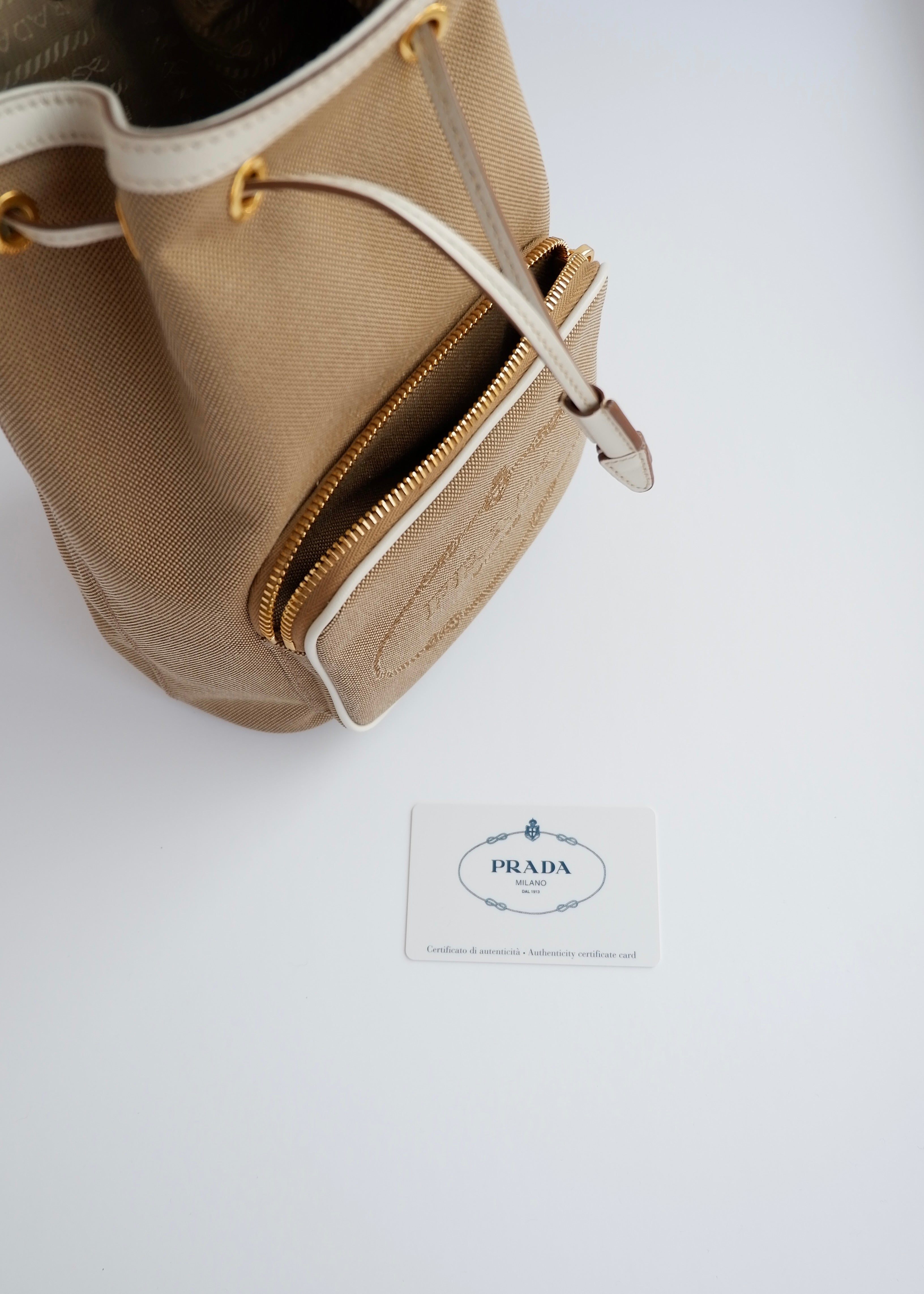 Sac seau à cordon Prada d'occasion authentique en toile beige