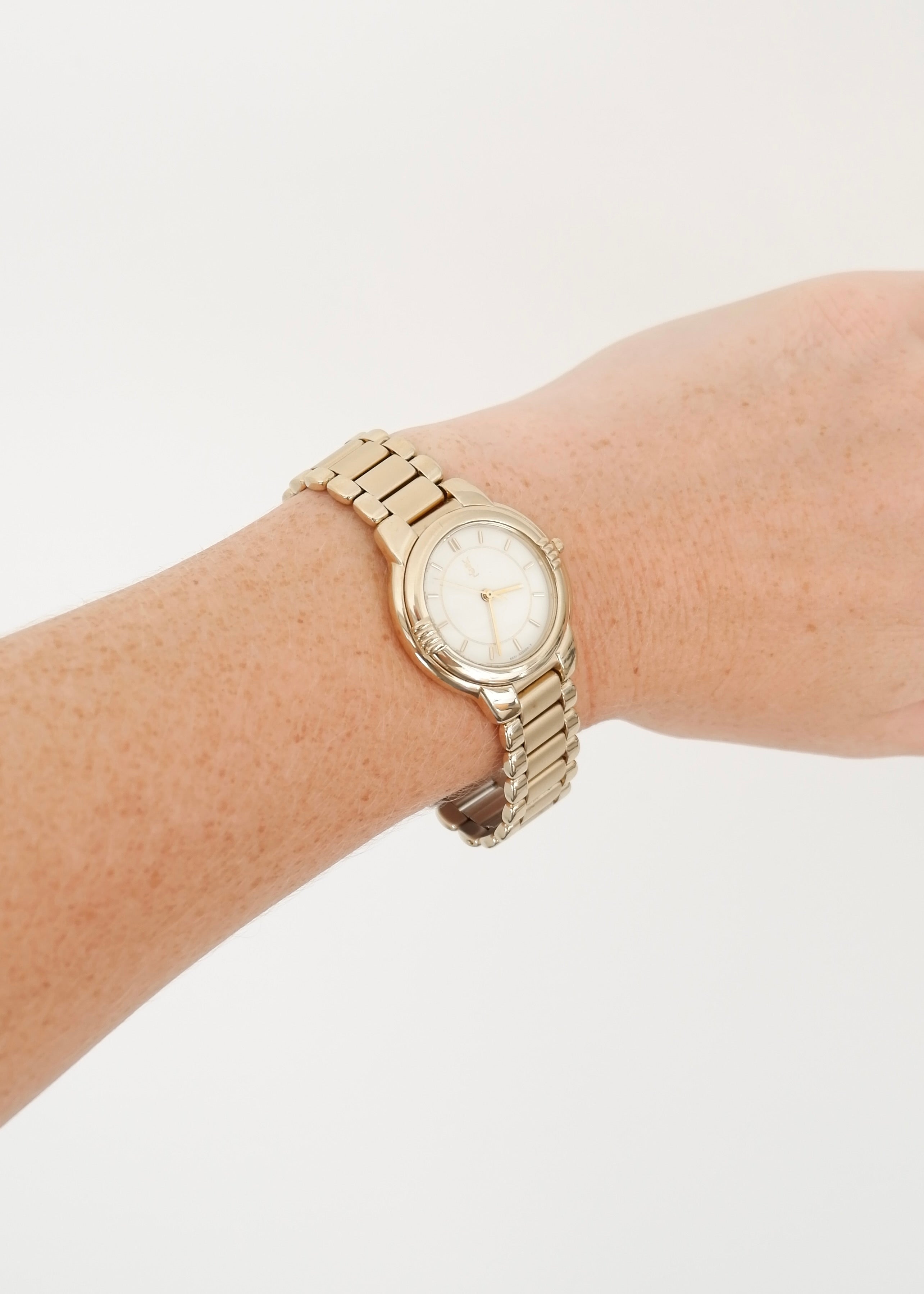 Montre vintage YSL authentique d'occasion, ton doré
