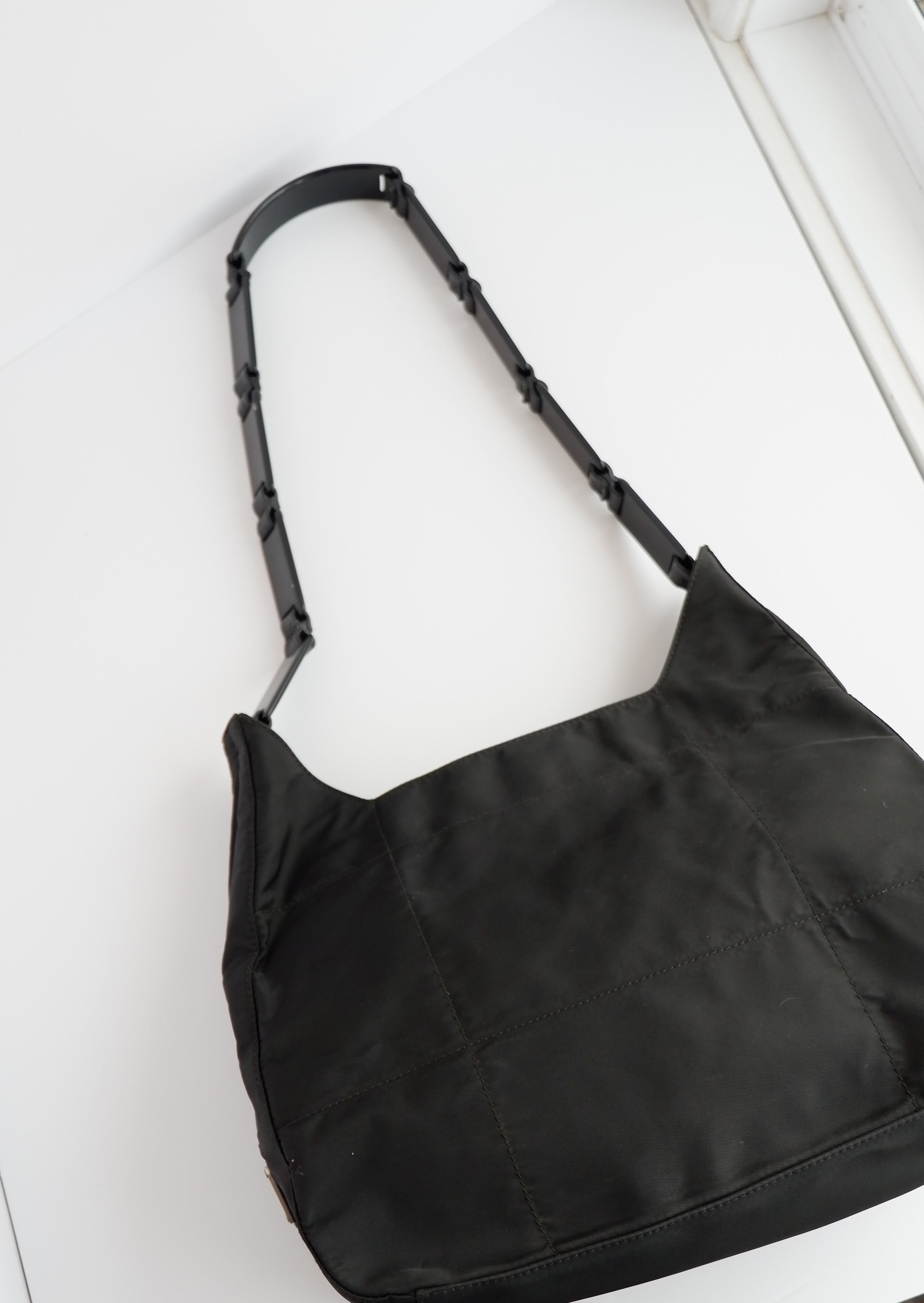 Authentique sac à bandoulière Prada en nylon noir avec longue sangle en plastique, d'occasion