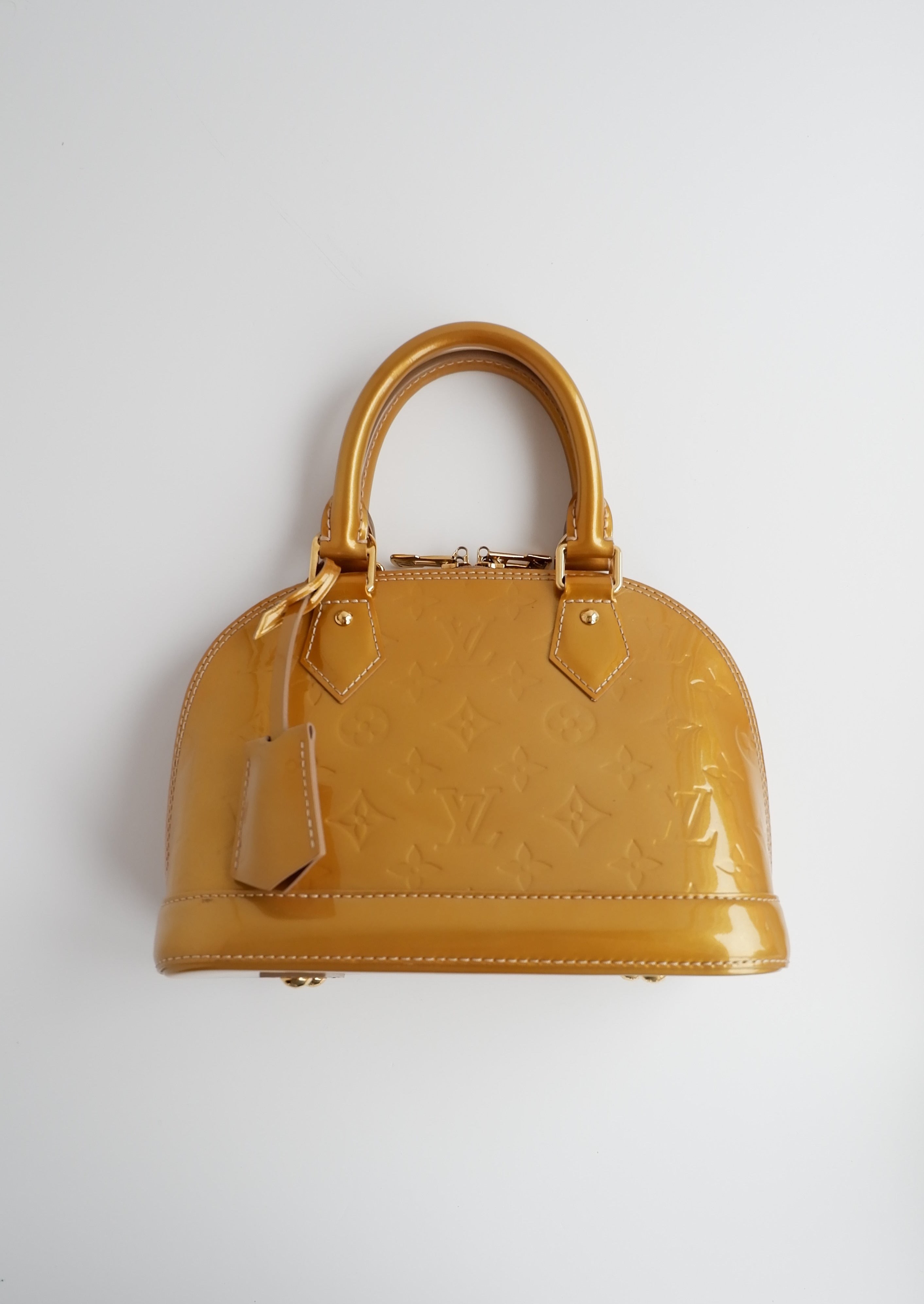 Authentique sac Louis Vuitton Monogram Gold Vernis Alma BB d'occasion