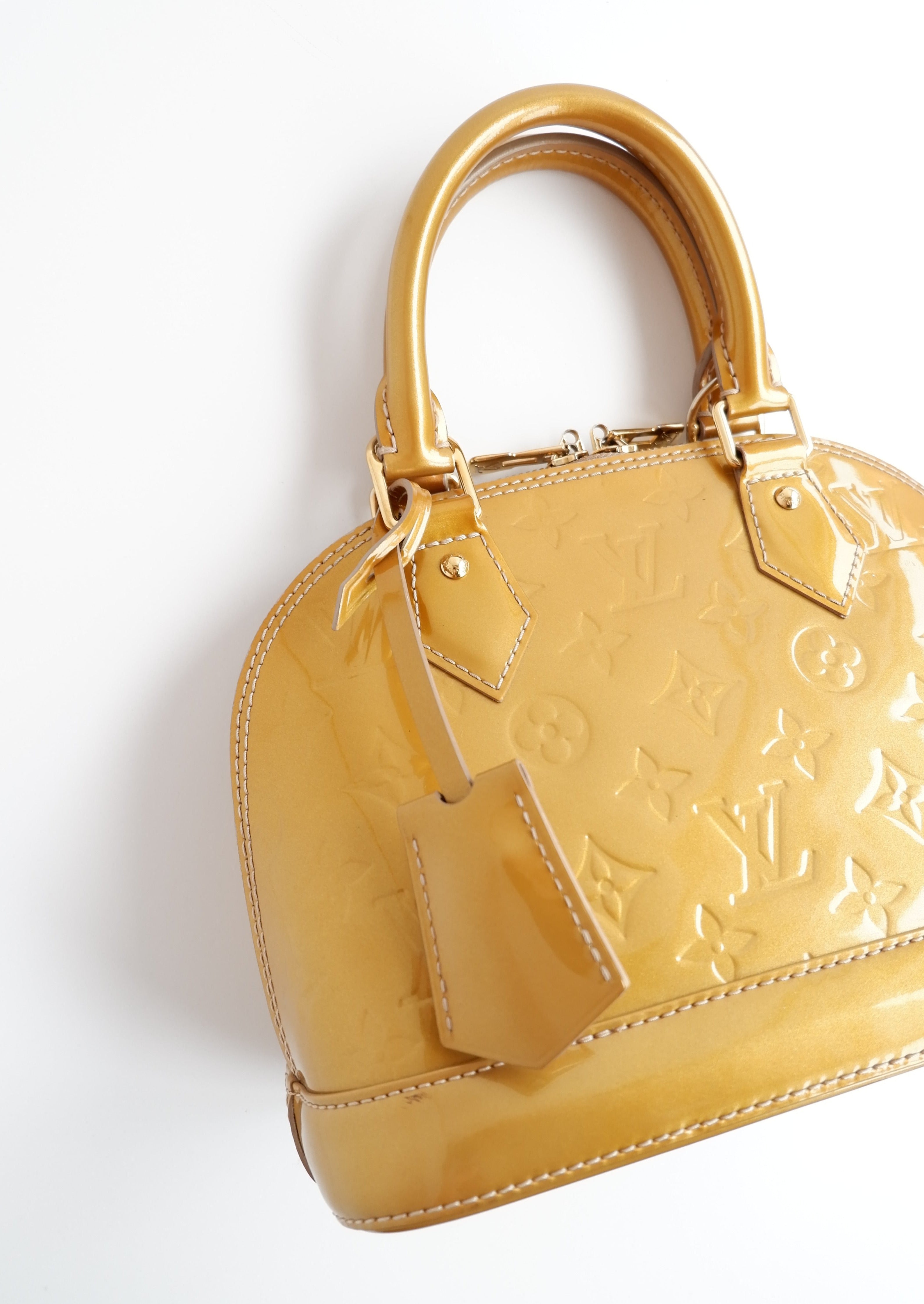 Authentique sac Louis Vuitton Monogram Gold Vernis Alma BB d'occasion