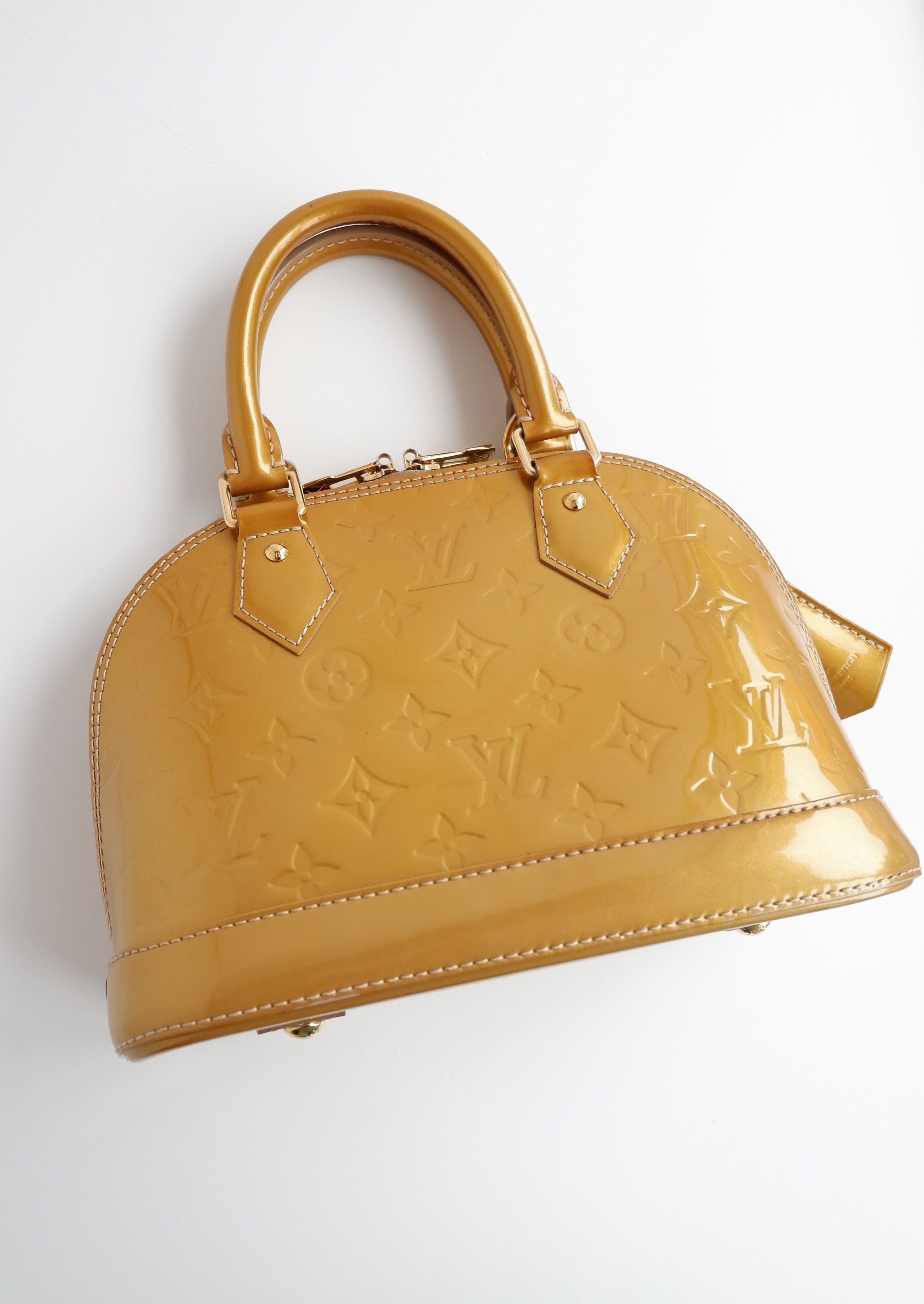 Authentique sac Louis Vuitton Monogram Gold Vernis Alma BB d'occasion